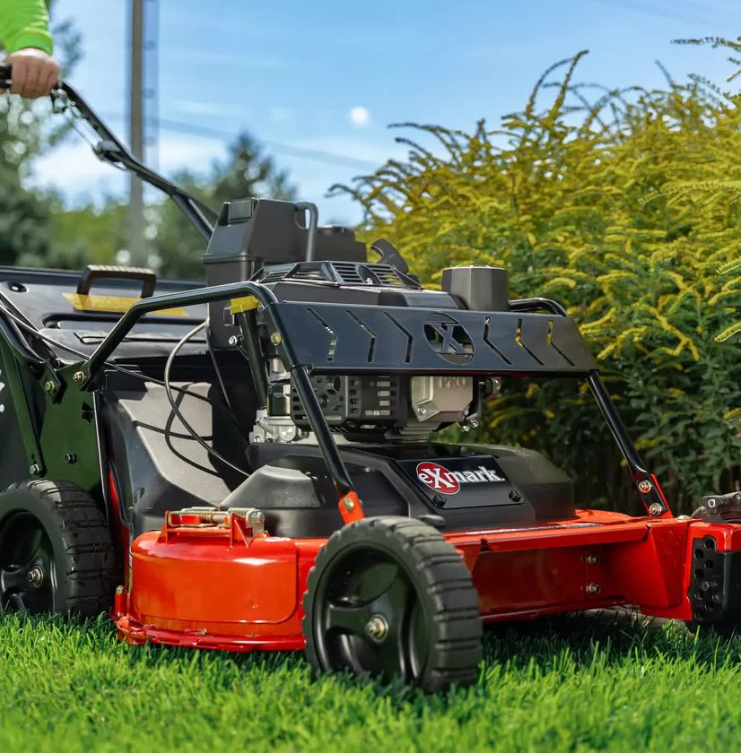 A high-quality Exmark lawnmower expertly trimming the edge of a lawn.
