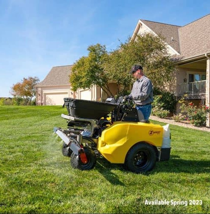 Professional lawn care specialist using a Z Spray machine to apply lawn treatments, ensuring a healthy and vibrant lawn.